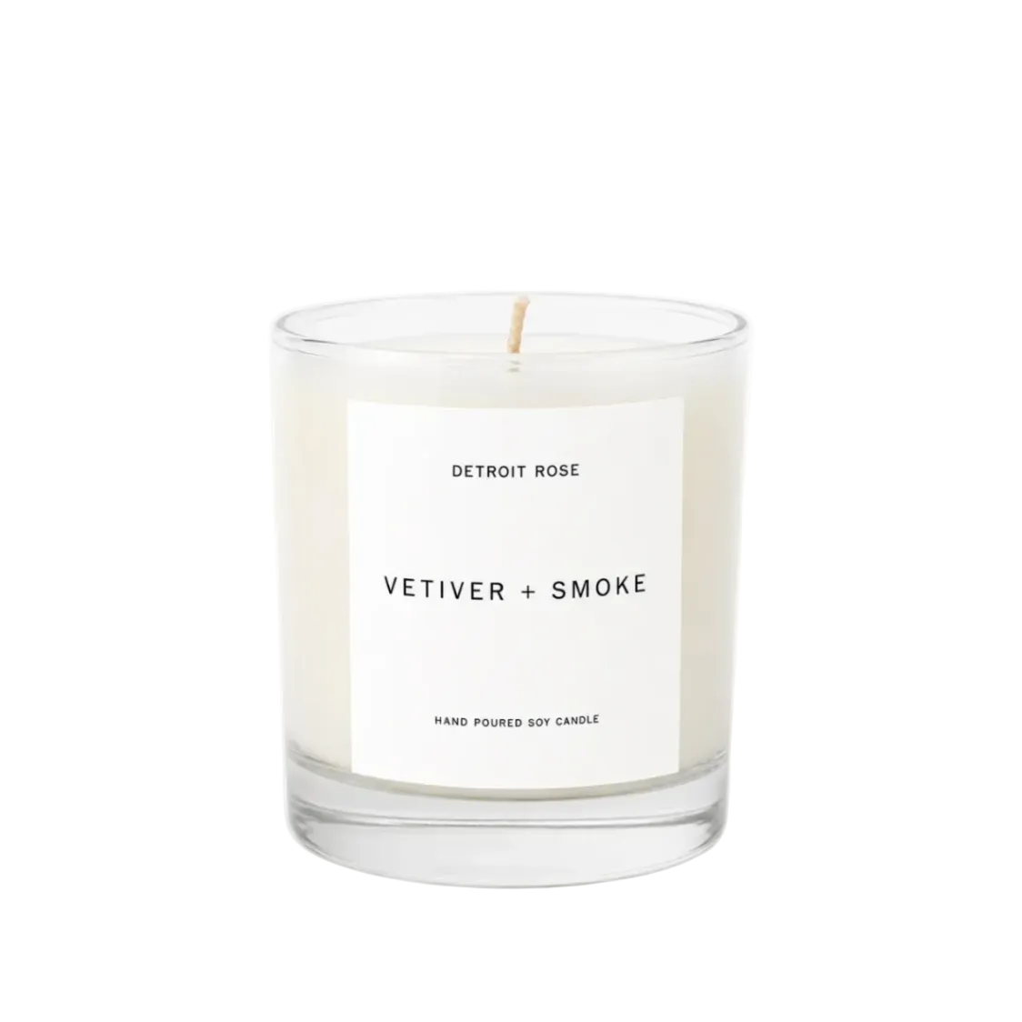 Candle with a label reading 'Vetiver + Smoke' on a white background
