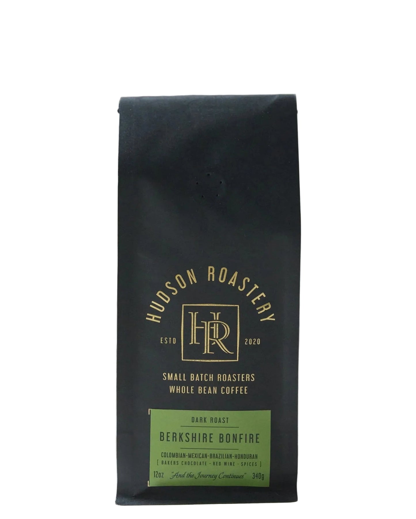 Hudson Roastery coffee package on a wooden surface with a stone background