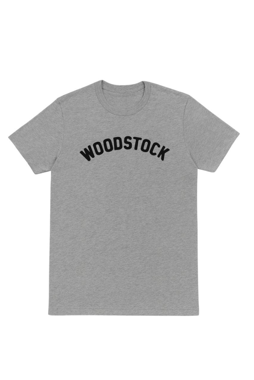 Gray t-shirt with 'Woodstock' text on a white background