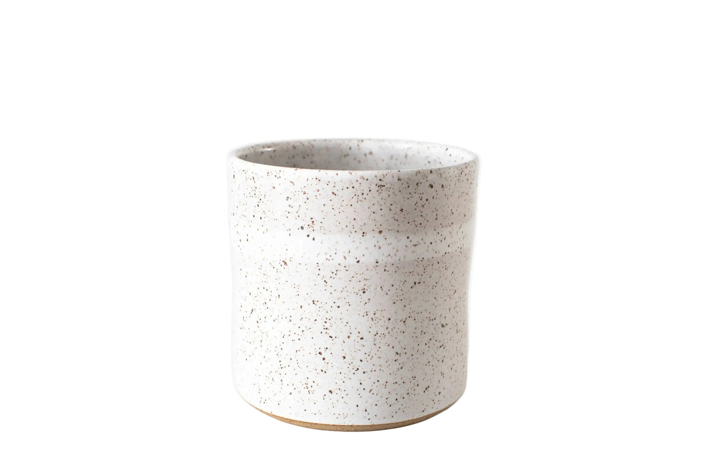 Speckled ceramic cup on a white background