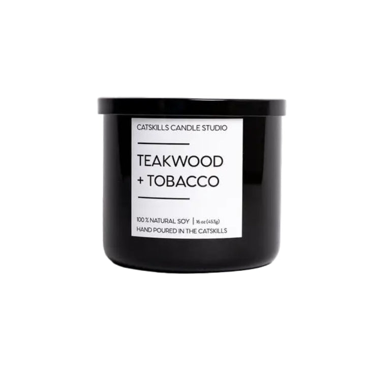 Black candle with 'Teakwood + Tobacco' label on a white background