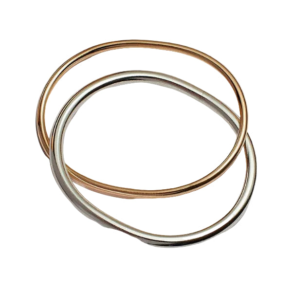 Two gold rings stacked on a white background