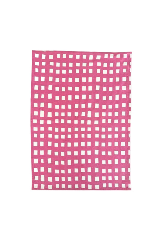 Pink checkered fabric with white squares on a pink background