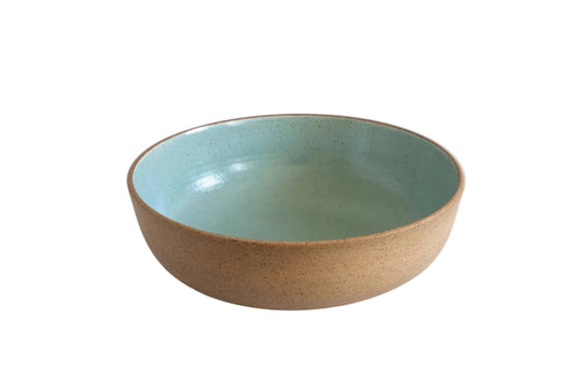 A ceramic bowl with a speckled beige exterior and a glossy light blue-green glazed interior, shown against a plain white background.