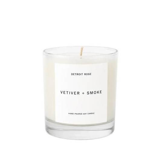 Candle with a label reading 'Vetiver + Smoke' on a white background