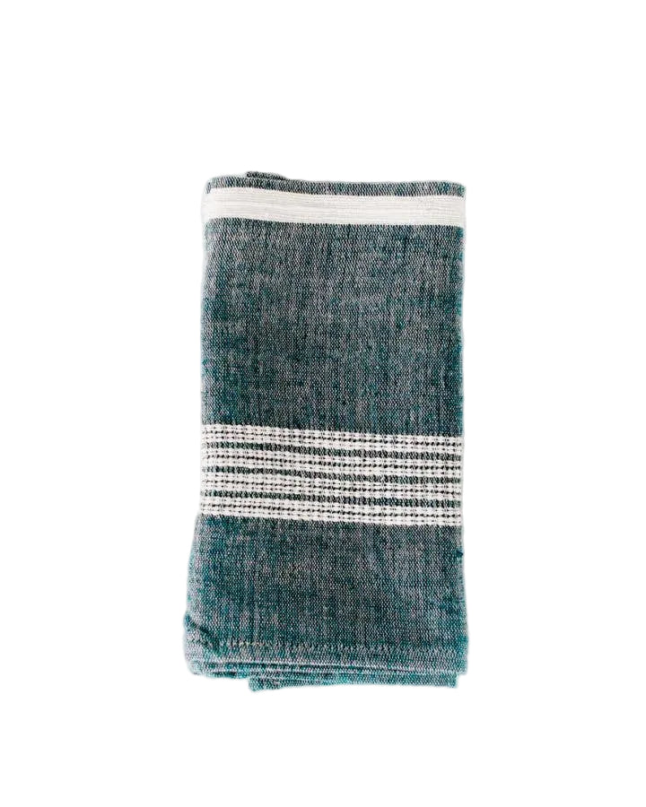 Folded teal towel with white stripes on a white background
