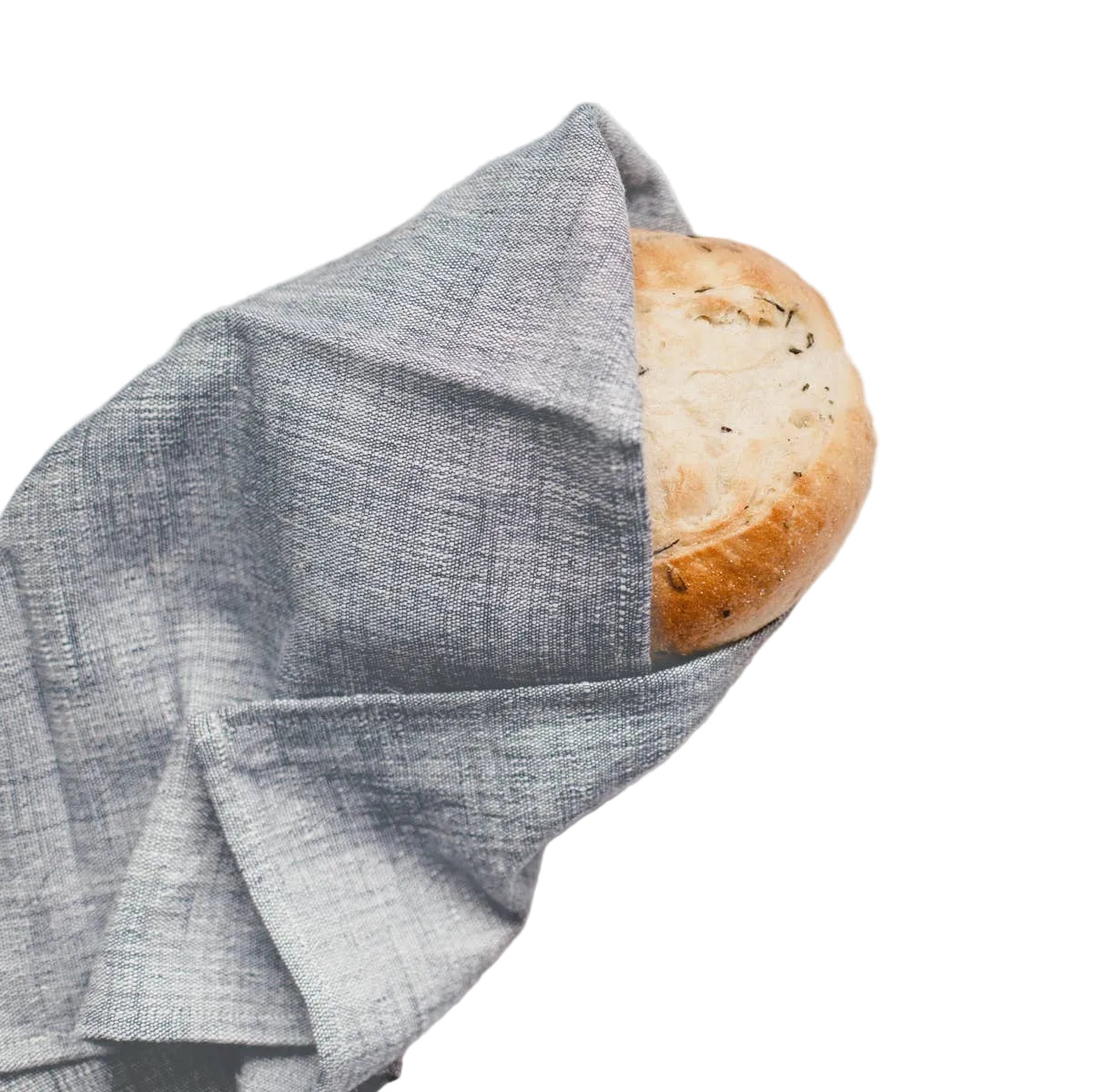 Loaf of bread wrapped in a gray cloth on a light surface