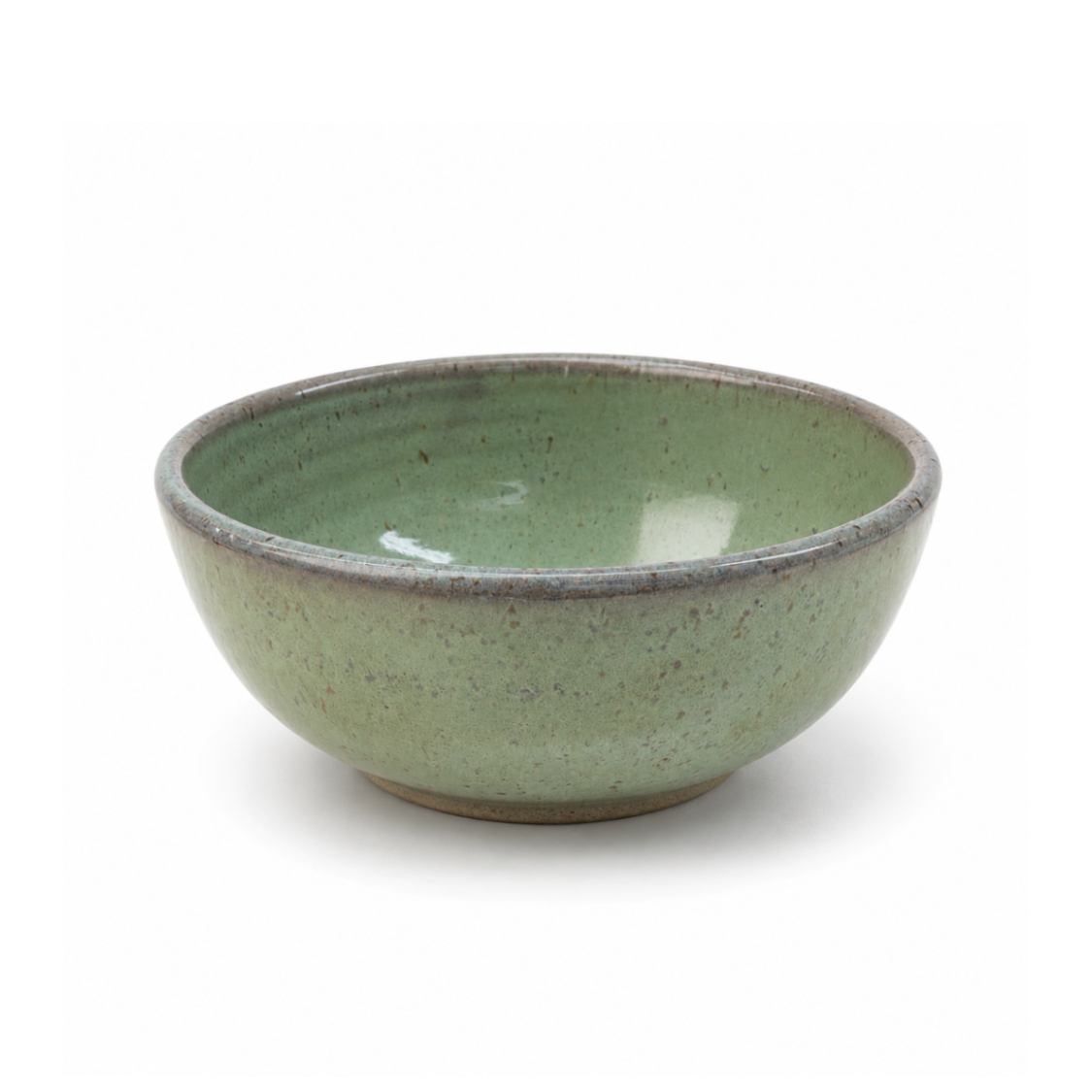 A handmade ceramic bowl with a speckled sage green glaze and a contrasting rustic brown rim, shown on a clean white background.