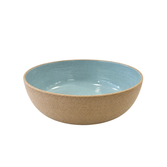 A ceramic bowl with a speckled beige exterior and a smooth, glossy light blue interior, photographed on a clean white background.