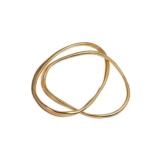 Two gold bangles on a white background