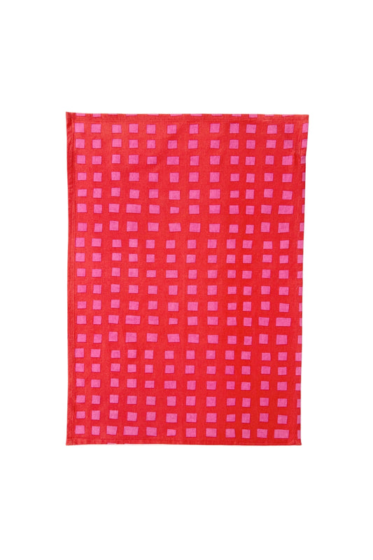 Red and pink checkered fabric on a white background