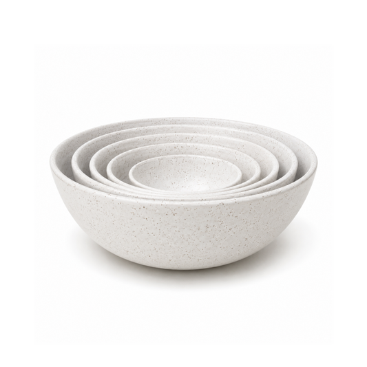 A set of five nested ceramic bowls in a light speckled off-white glaze, shown on a clean white background.
