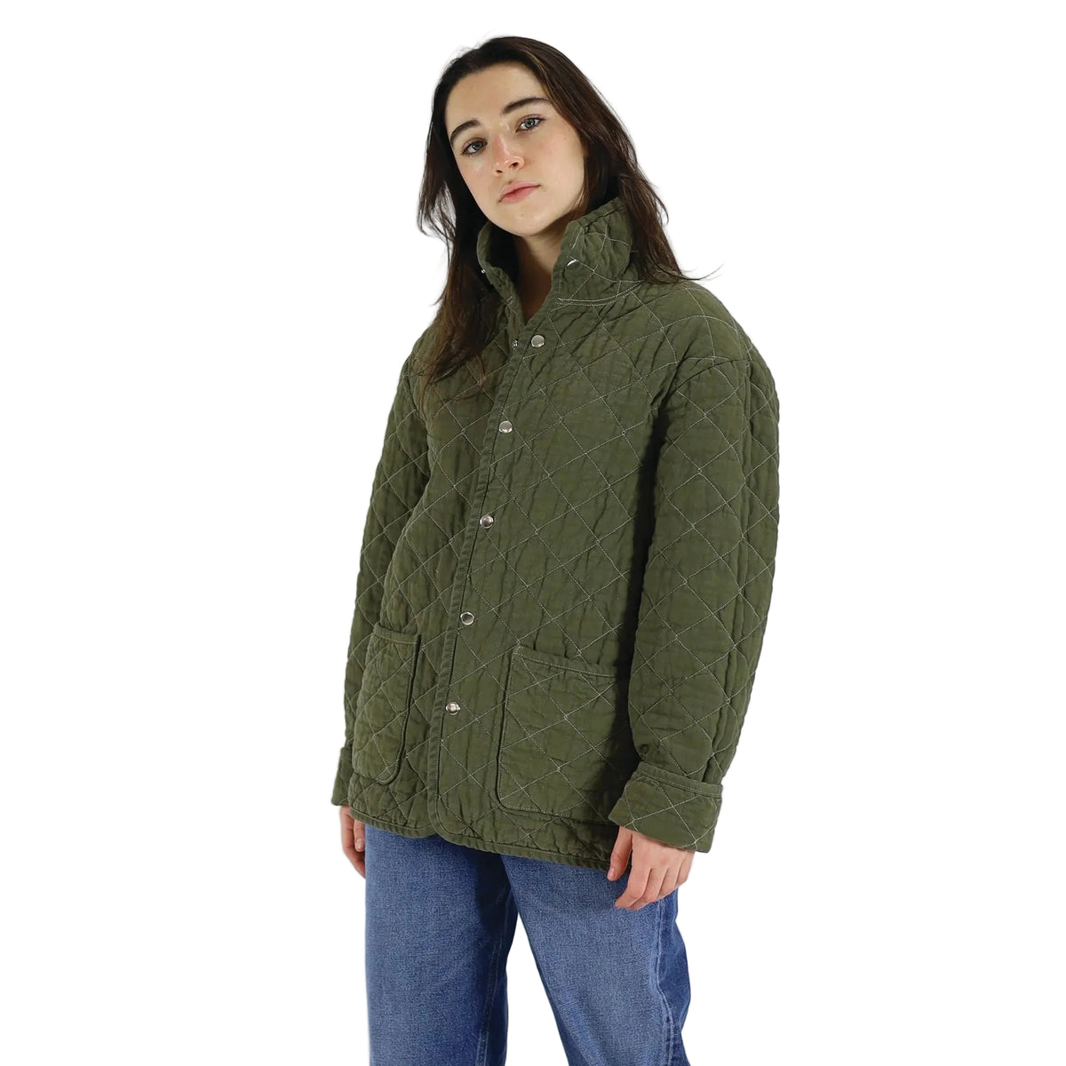 Person wearing a green quilted jacket on a white background