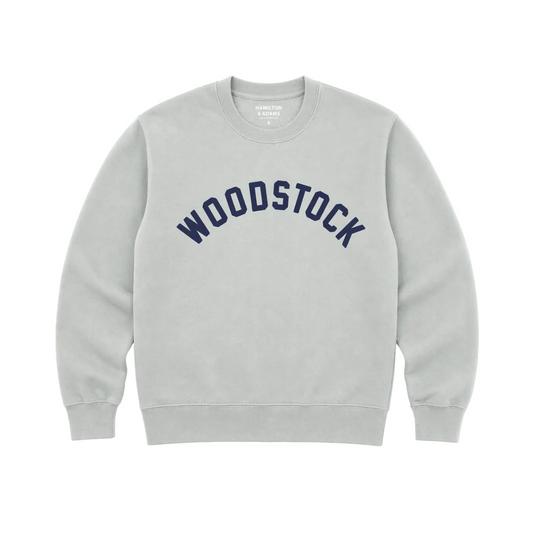 Gray sweatshirt with 'Woodstock' text on a white background