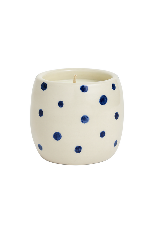 Ceramic candle with blue polka dots on a white background