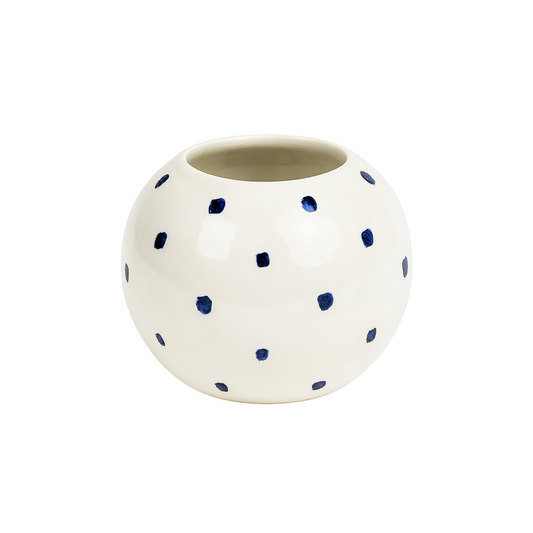 White ceramic pot with blue polka dots on a white background