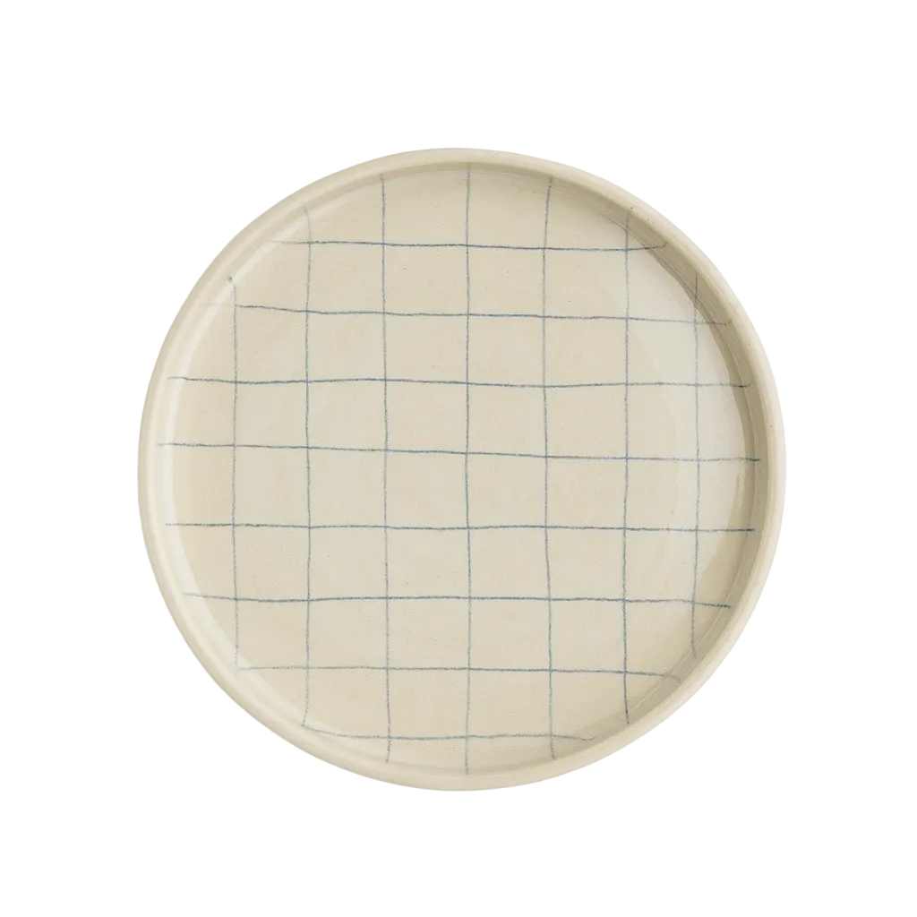 Round ceramic plate with grid pattern on a white background