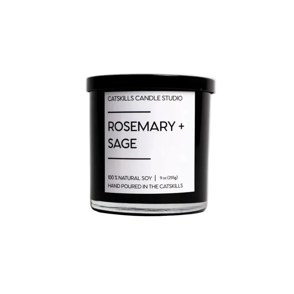 Candle with 'Rosemary + Sage' label on a white background