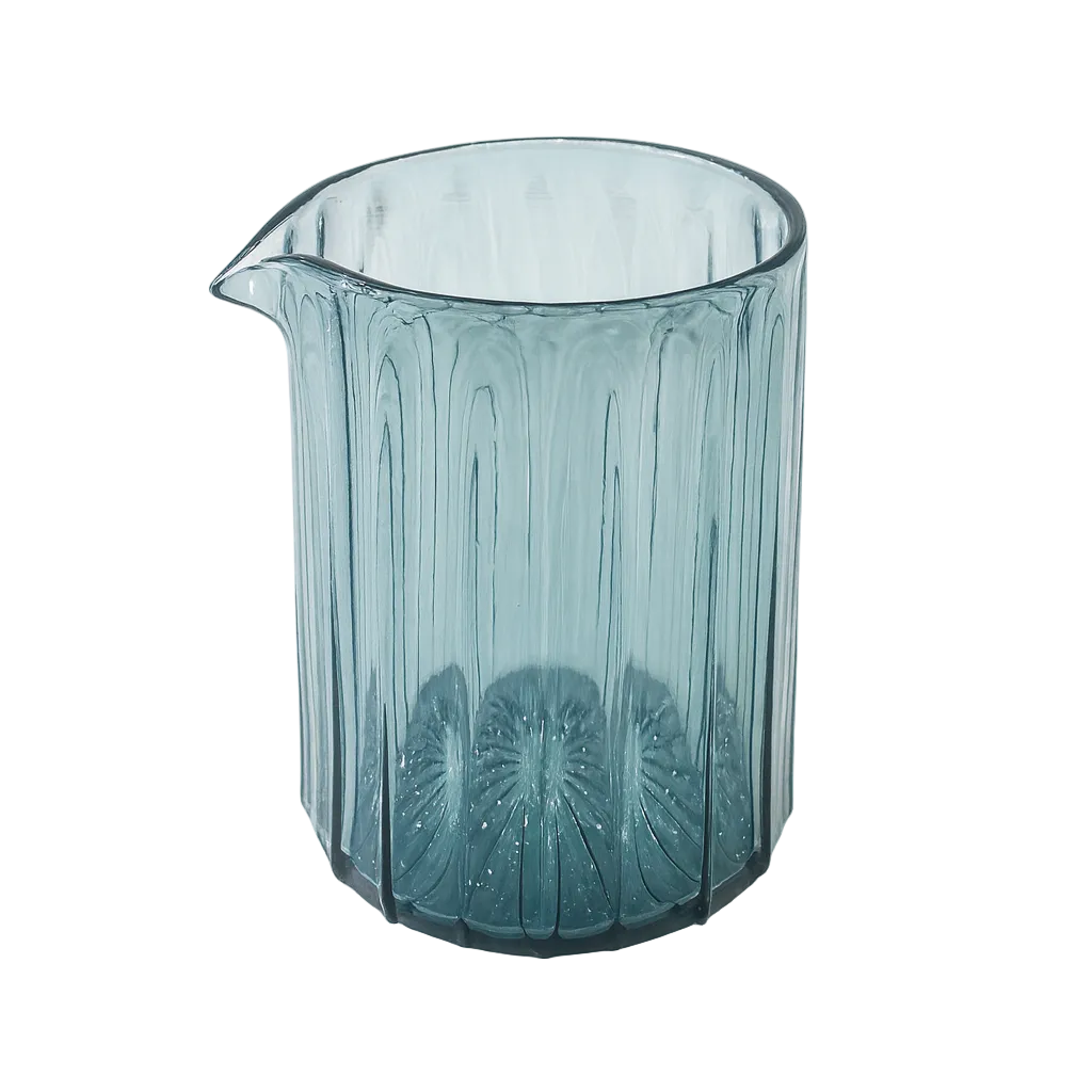Teal glass pitcher with textured design on a white background
