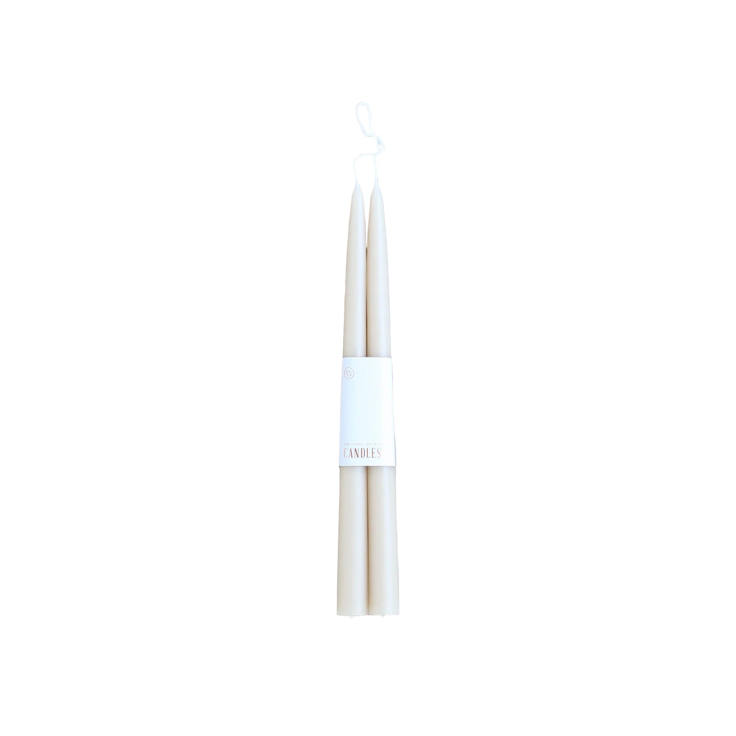 Two white candles with a label on a light gray background