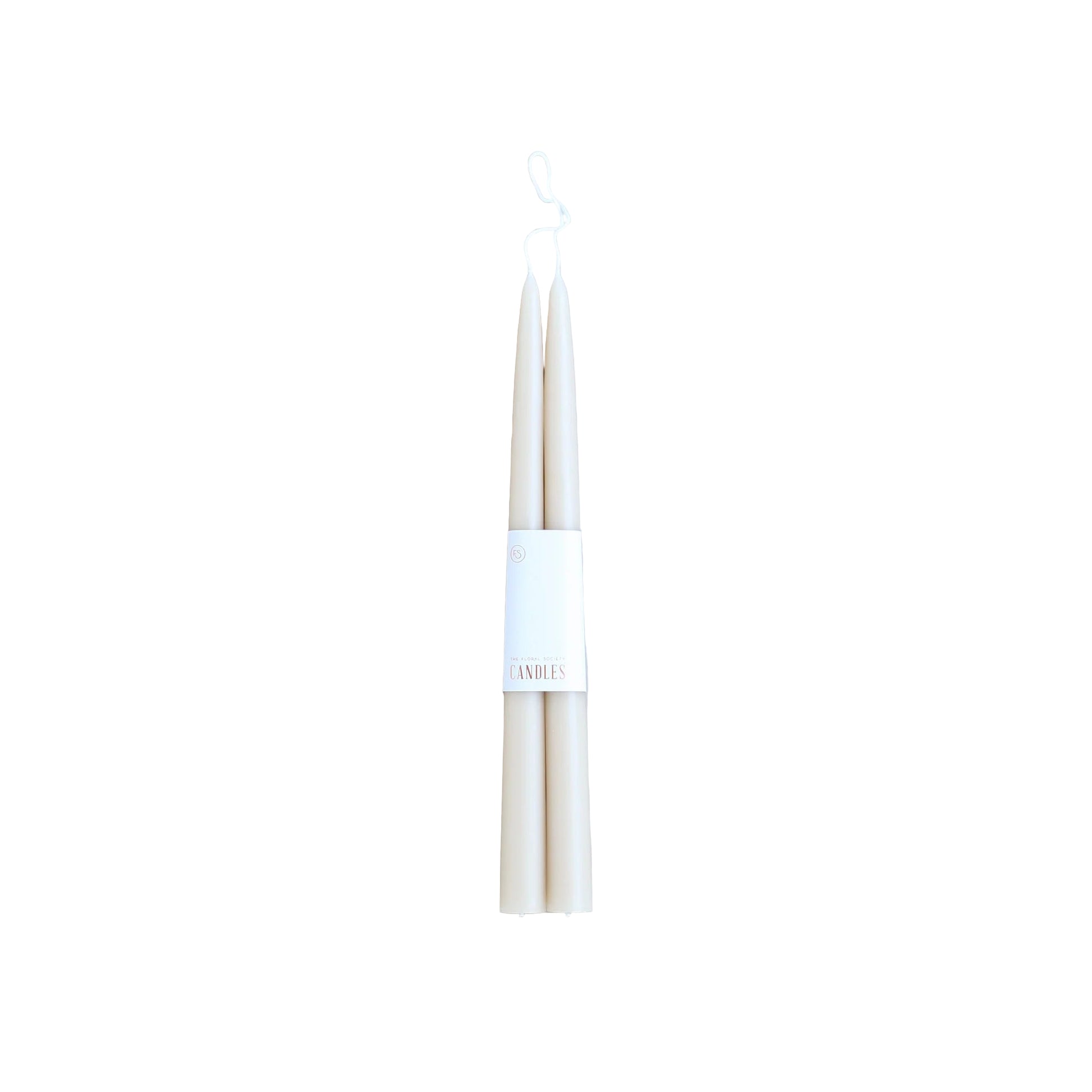 Two white candles with a label on a light gray background