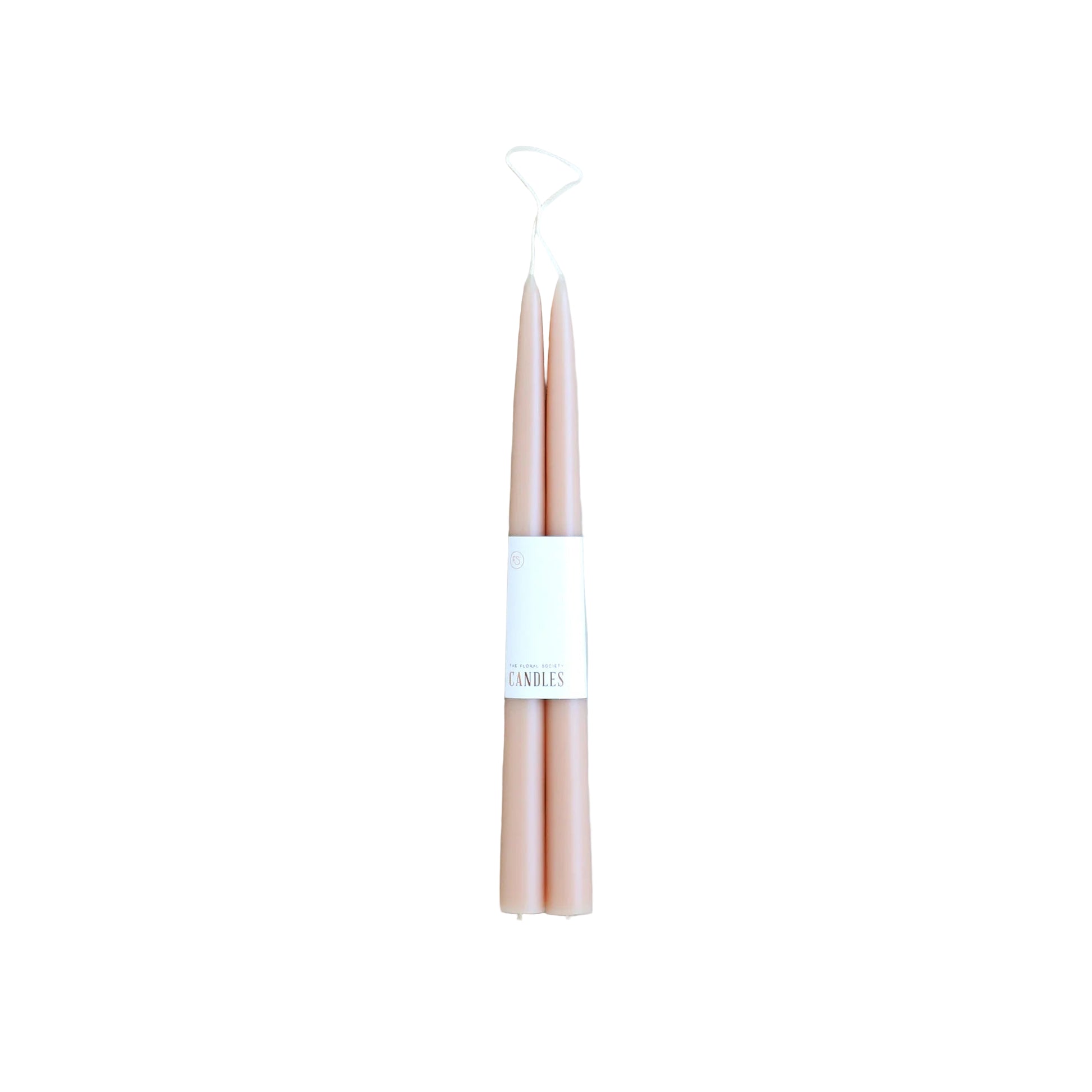 Pair of pink candles with a white label on a light gray background