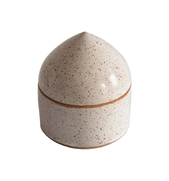 Speckled ceramic salt box with a brown rim on a light gray background
