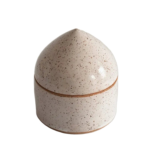 Speckled ceramic salt box with a brown rim on a light gray background